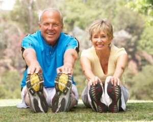 Senior Couple Exercising In Park