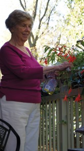 Woman tending flowers on patio