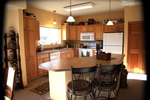 Smaller kitchen with island and chairs