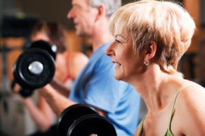 Exercising with weights - woman in foreground